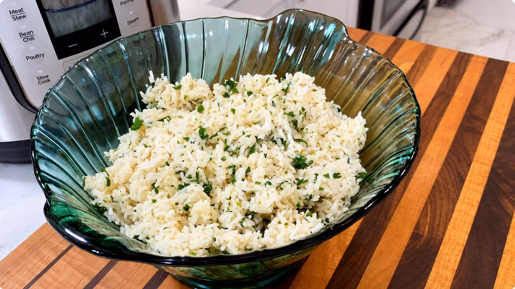 Fluffy jasmine rice with fresh chopped cilantro and lime zest in a white bowl.