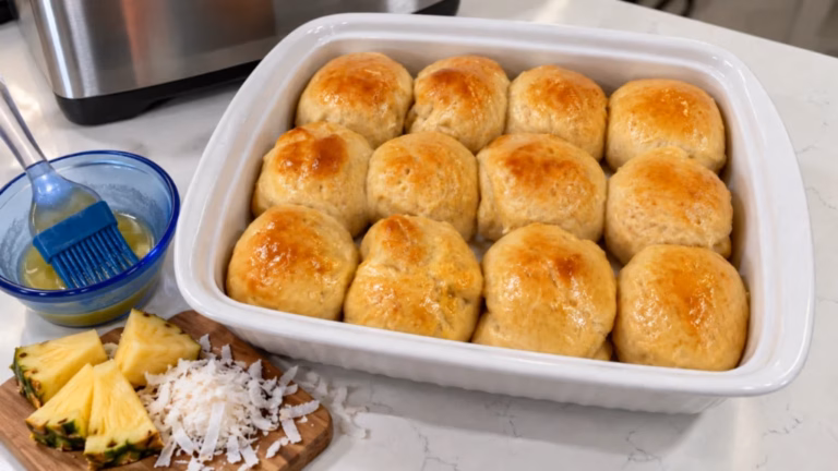 Soft homemade Hawaiian rolls baked together in a rectangular casserole dish.